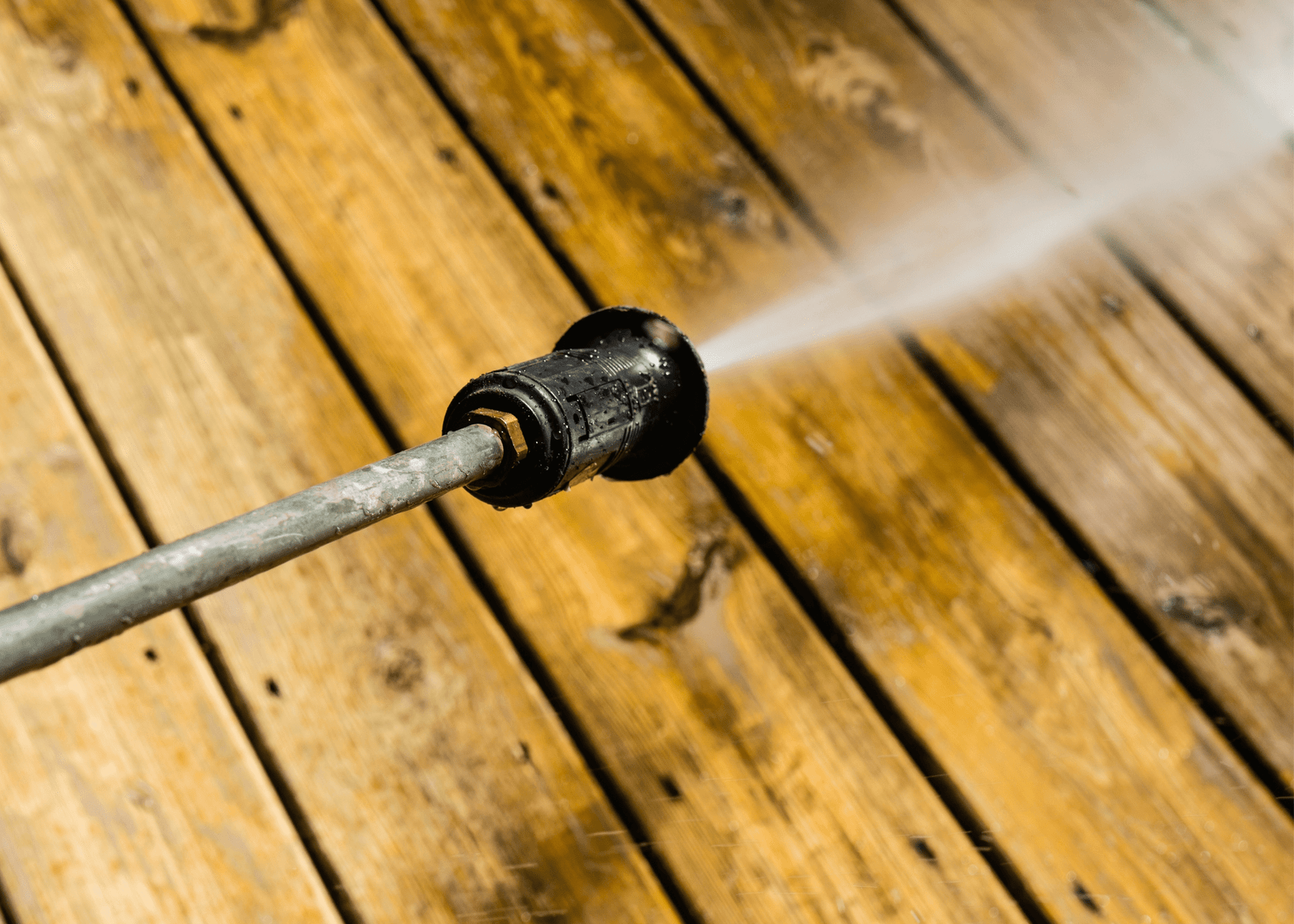 Deck Cleaning with High-Pressure Power Washer by Handyman Jax in Jacksonville, FL High-pressure power washer removing dirt and old stain from a deck, part of Handyman Jax's Cleaning Services in Jacksonville, FL
